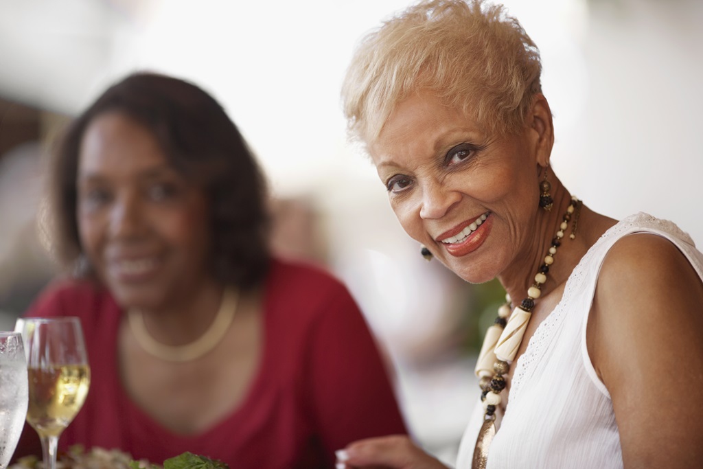 senior woman glancing at camera while dining