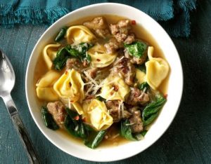 white bowl of sausage, spinach and tortellini soup 