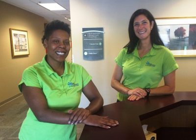 two women standing at desk in exercise facility