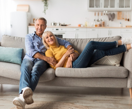 Senior couple at home on couch